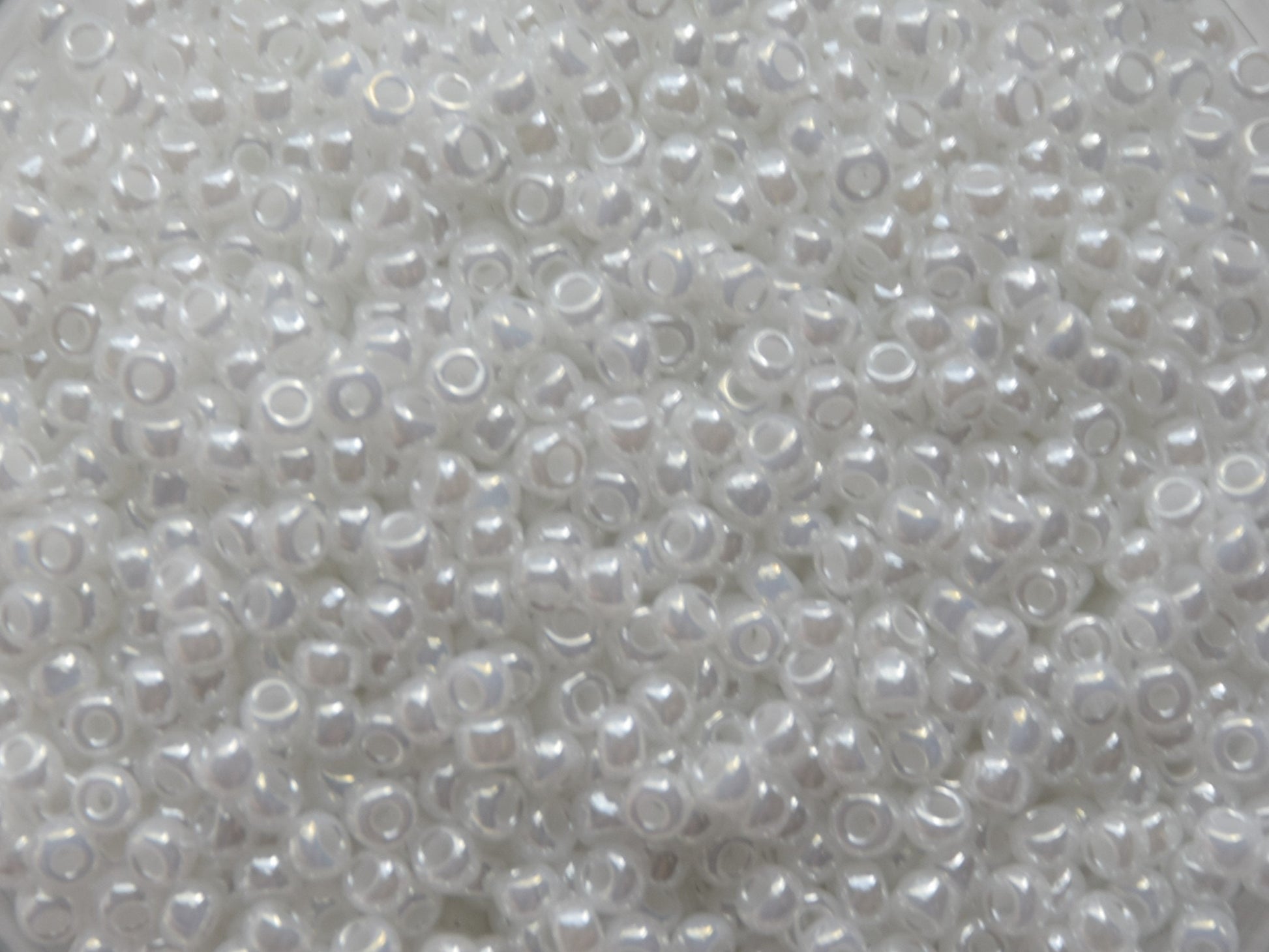 Shiny white seed beads, 3mm in size, round shape.