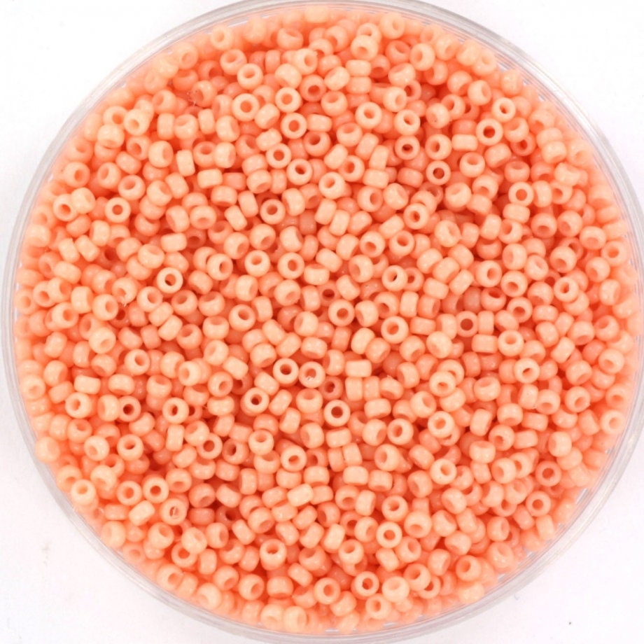 Light pink seed beads. The beads are made of glass. Each bead measures 1.5mm and has a 0.7mm hole.