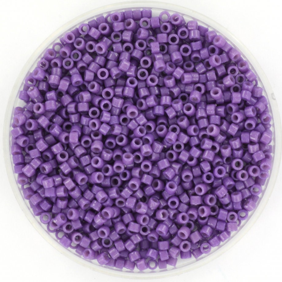 Miyuki Delica beads size 11/0, color duracoat opaque anemone. The beads are made of glass and in cylindrical shape. The color is dark purple.