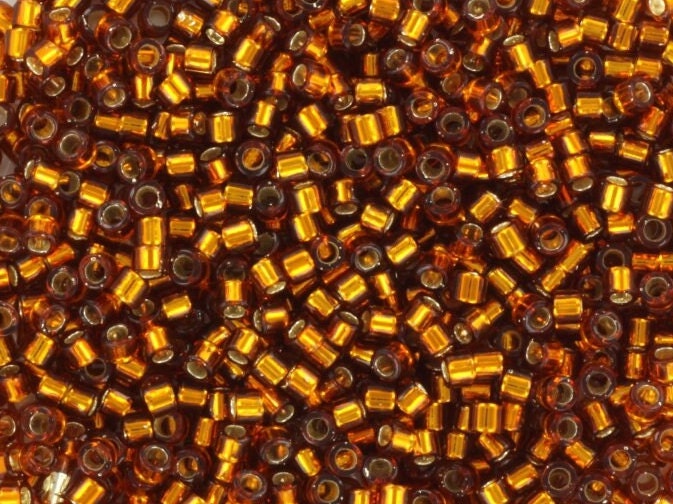 Miyuki Delica beads silverlined dark topaz, 5g 11/0 DB144, cylindrical beads, size 1.6mm, transparent brown Miyuki, color DB 144, amber