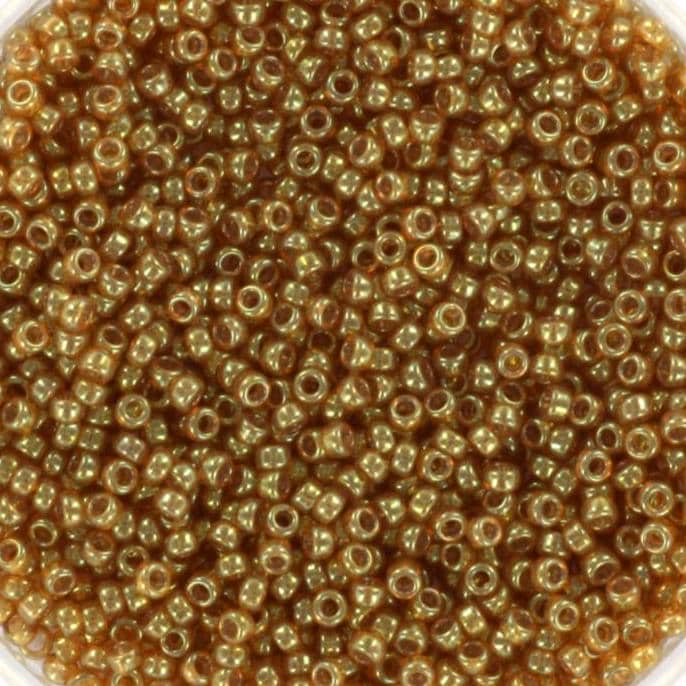 Translucent brown gold tiny round glass beads. Each bead is 1.5mm big.